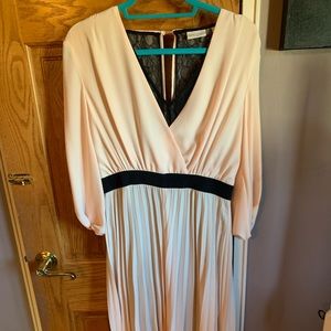 Baby pink dress, black lace underlay. Pleated front.